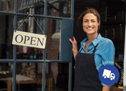 Women standing in front of store door with open sign