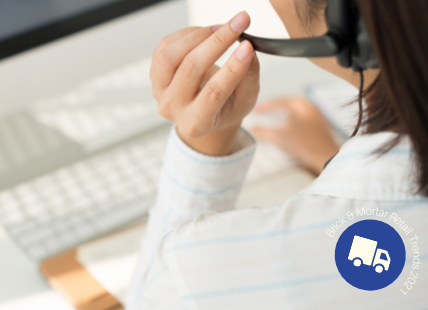 women on headset in front of computer