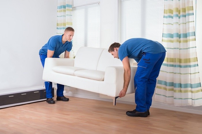 Movers lifting sofa